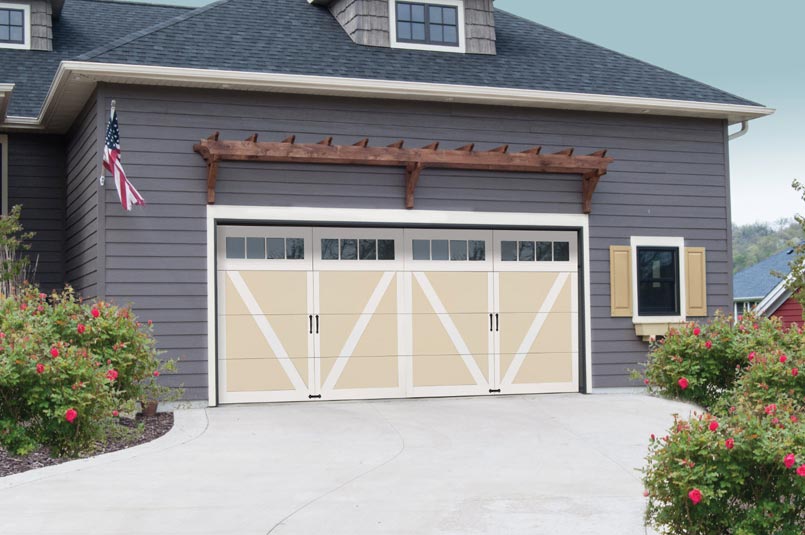 New garage doors on a large, grey home
